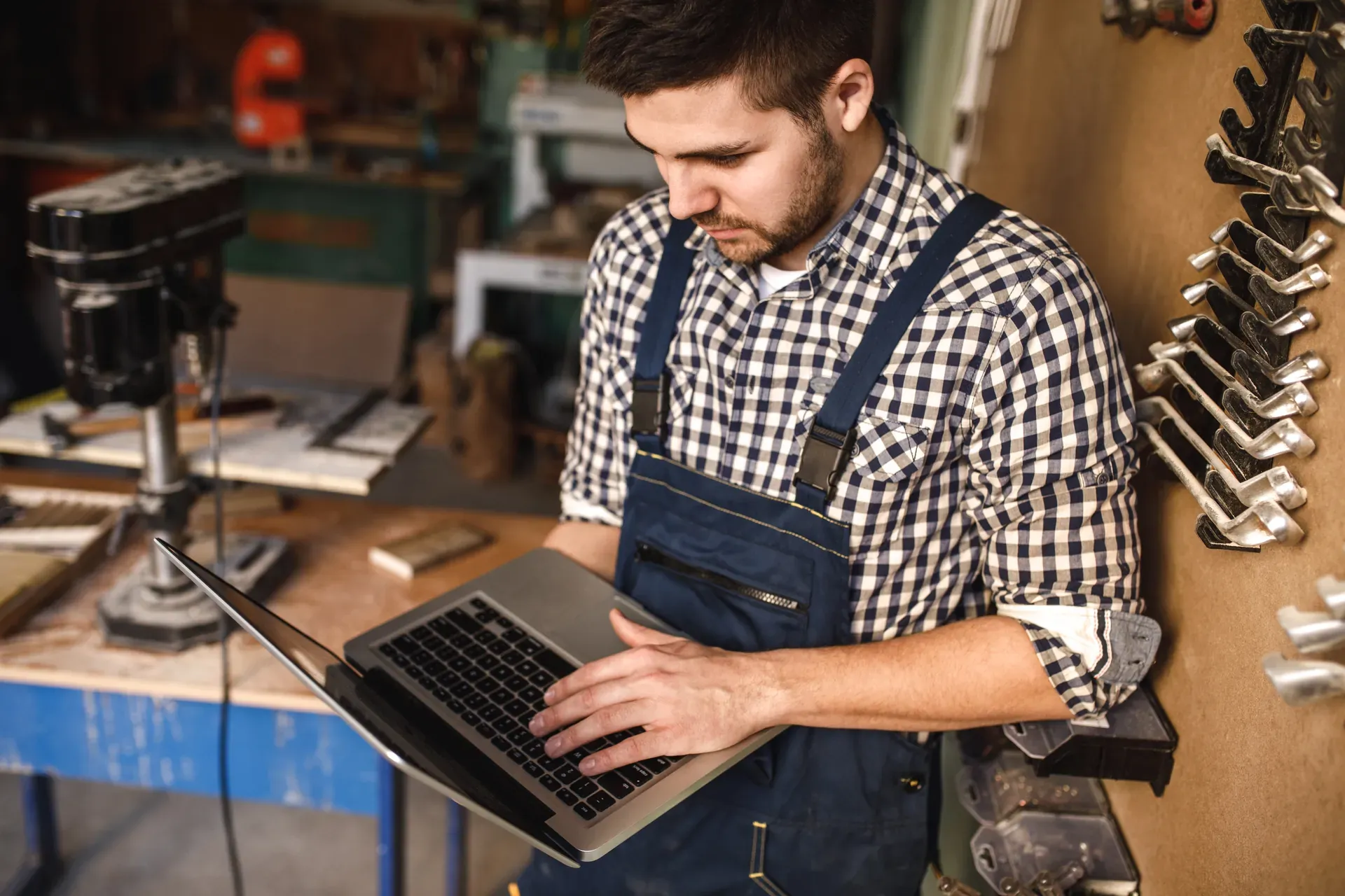 A tradesperson reviewing their business on a laptop